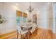 Well-lit dining room with wood floors, complemented by a modern chandelier and large windows at 2701 Fountainhead Way, Mount Pleasant, SC 29466