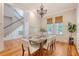 Bright dining room showcasing a modern chandelier, staircase, and seating for six at 2701 Fountainhead Way, Mount Pleasant, SC 29466