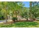 View of the home's exterior from the yard showcasing professional landscaping and mature trees at 2701 Fountainhead Way, Mount Pleasant, SC 29466