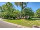 Landscaped front yard with lush greenery and mature trees surrounding the house at 2701 Fountainhead Way, Mount Pleasant, SC 29466