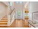 Bright foyer featuring hardwood floors, white trim, a staircase, and abundant natural light at 2701 Fountainhead Way, Mount Pleasant, SC 29466