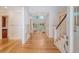 Grand foyer showcasing gleaming hardwood floors, elegant wainscoting, and an open staircase at 2701 Fountainhead Way, Mount Pleasant, SC 29466