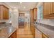 Bright kitchen boasts stainless steel appliances, wood cabinets, granite countertops, and hardwood floors at 2701 Fountainhead Way, Mount Pleasant, SC 29466