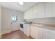 Laundry room with white cabinets, countertop space, a sink, and an exterior door at 2701 Fountainhead Way, Mount Pleasant, SC 29466