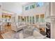 Bright living room with large windows, a fireplace, and open access to the dining area at 2701 Fountainhead Way, Mount Pleasant, SC 29466