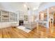 Expansive living area with fireplace, built-in shelves, bar seating, and wood flooring at 2701 Fountainhead Way, Mount Pleasant, SC 29466