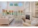 Spacious living room with tall windows, fireplace, built-in shelving, and comfortable seating at 2701 Fountainhead Way, Mount Pleasant, SC 29466