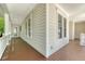 Expansive covered porch with classic architecture, wood flooring and ample natural light at 2701 Fountainhead Way, Mount Pleasant, SC 29466