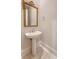 Powder room with a pedestal sink, ornate mirror, and updated fixtures at 2701 Fountainhead Way, Mount Pleasant, SC 29466