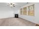 Inviting living room with a cozy fireplace, ceiling fan, and plenty of natural light at 272 Overcup Loop, Summerville, SC 29486