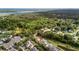 An aerial view of a lush neighborhood with homes nestled among trees, a pond, and coastal views at 3000 Treadwell St, Mount Pleasant, SC 29466