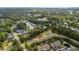 Aerial view of neighborhood featuring mature trees, well-maintained lawns, and a community pond at 3000 Treadwell St, Mount Pleasant, SC 29466