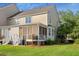 A home's backyard with a screened porch, a grill, steps and grassy lawn on a sunny day at 3000 Treadwell St, Mount Pleasant, SC 29466