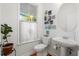Bright bathroom featuring a pedestal sink, and stylish decor above the toilet at 3000 Treadwell St, Mount Pleasant, SC 29466