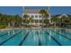 Spacious community pool with clearly marked lanes, a building with white pillars, and mature landscaping at 3000 Treadwell St, Mount Pleasant, SC 29466