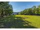 Stately home with lush green lawn and mature trees under a clear blue sky at 3000 Treadwell St, Mount Pleasant, SC 29466