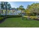 Inviting community clubhouse with lush green lawn, palm trees, and a bench offering a tranquil outdoor space at 3000 Treadwell St, Mount Pleasant, SC 29466