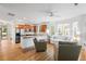 Open-concept living space with a kitchen island, hardwood floors, and lots of windows at 3000 Treadwell St, Mount Pleasant, SC 29466