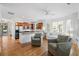Open-concept living space with a kitchen island, hardwood floors, and lots of windows at 3000 Treadwell St, Mount Pleasant, SC 29466