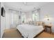 Bright main bedroom features a ceiling fan, three windows, and a small nightstand at 3000 Treadwell St, Mount Pleasant, SC 29466