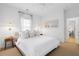 Comfortable main bedroom features three windows, sconce lighting, and stylish decor at 3000 Treadwell St, Mount Pleasant, SC 29466