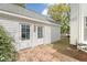 Exterior of a white house with a brick path leading to double doors and a green lawn at 304 Bank St, Mount Pleasant, SC 29464