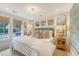 Bright and airy main bedroom with large windows, decorative pillows, and stylish nightstands at 304 Bank St, Mount Pleasant, SC 29464