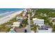 Expansive aerial view of a coastal community with beach access, showcasing a mix of homes and lush greenery at 313 E Arctic Ave, Folly Beach, SC 29439