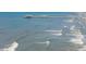 Aerial perspective of the ocean with a pier, gentle waves, and a sandy beach at 313 E Arctic Ave, Folly Beach, SC 29439
