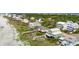Stunning aerial shot showcases coastal homes, wooden walkways, and lush vegetation near the beach at 313 E Arctic Ave, Folly Beach, SC 29439