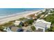 Panoramic aerial view displays charming beach houses with ocean access, coastal road, and lush trees at 313 E Arctic Ave, Folly Beach, SC 29439