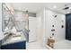 Sleek bathroom showcases double vanity, pendant lighting, and access to a luxurious, tiled shower at 313 E Arctic Ave, Folly Beach, SC 29439