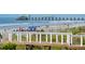 Scenic beach view with families enjoying the ocean, a pier, and a beach access walkway at 313 E Arctic Ave, Folly Beach, SC 29439