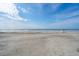 Expansive beach with a serene ocean view and gentle waves lapping the sandy shore at 313 E Arctic Ave, Folly Beach, SC 29439