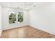An bright, airy bedroom showcasing hardwood floors, a ceiling fan, and lots of light from the window at 313 E Arctic Ave, Folly Beach, SC 29439