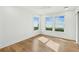Bright bedroom with large windows offering beach views, wooden flooring, and neutral walls at 313 E Arctic Ave, Folly Beach, SC 29439
