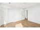 An airy bedroom with hardwood floors, white walls, recessed lighting, and closet with double doors at 313 E Arctic Ave, Folly Beach, SC 29439