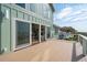 Wooden deck providing stunning ocean views and access to the interior through sliding glass doors at 313 E Arctic Ave, Folly Beach, SC 29439