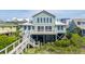 Attractive coastal home featuring a large deck, multiple windows, and a well-maintained entrance at 313 E Arctic Ave, Folly Beach, SC 29439