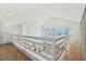 Bright hallway boasts ocean views from windows and overlooks main floor at 313 E Arctic Ave, Folly Beach, SC 29439