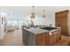 Modern kitchen featuring a large island with seating, stylish pendant lighting, and a view of the ocean beyond at 313 E Arctic Ave, Folly Beach, SC 29439