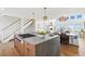 Open-concept kitchen with marble island, connecting seamlessly to the dining and living areas, perfect for entertaining at 313 E Arctic Ave, Folly Beach, SC 29439