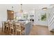 Bright, open kitchen featuring an island with seating and a gas cooktop, seamlessly blending style and functionality at 313 E Arctic Ave, Folly Beach, SC 29439