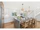 The kitchen features a large island with seating and marble countertops, complemented by modern appliances and fixtures at 313 E Arctic Ave, Folly Beach, SC 29439