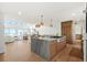 Spacious kitchen with a large island, modern appliances, and a seamless transition to the bright living area at 313 E Arctic Ave, Folly Beach, SC 29439
