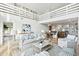 Bright living room with open floor plan, hardwood floors, and white furnishings at 313 E Arctic Ave, Folly Beach, SC 29439