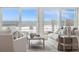Comfortable living room offering stunning ocean views through large windows and sliding glass doors at 313 E Arctic Ave, Folly Beach, SC 29439