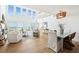 Open-concept living space with high ceilings, large windows showcasing ocean views, and stylish coastal-inspired decor at 313 E Arctic Ave, Folly Beach, SC 29439