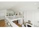 Bright living area with a fireplace and wooden floors viewed from an overhead balcony at 313 E Arctic Ave, Folly Beach, SC 29439