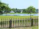 Picturesque backyard boasts serene lake views framed by a charming wooden fence at 3254 Hartwell St, Johns Island, SC 29455